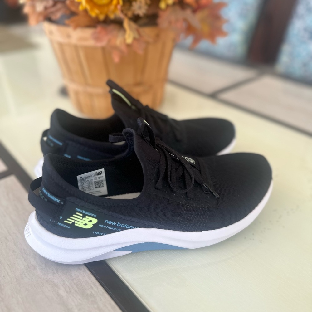 New Balance Black Knit Athletic Slip-On Sneakers with White and Blue Sole